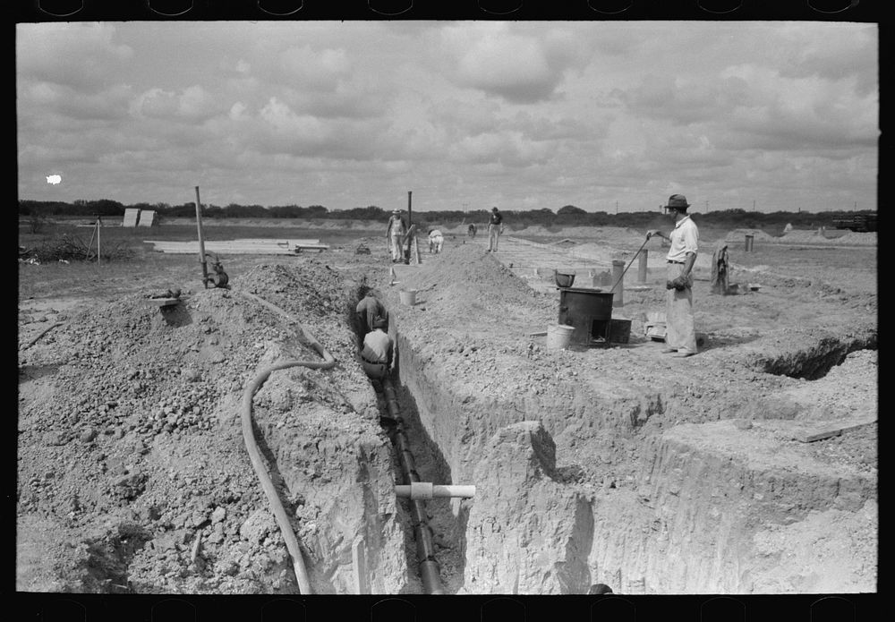 Laying sewer pipe at migrant camp under construction at Sinton, Texas by Russell Lee