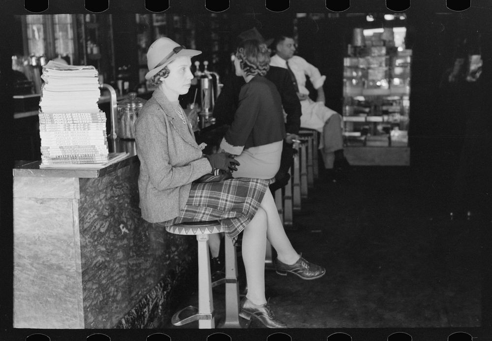 Woman sitting at soda fountain, Taylor, Texas by Russell Lee