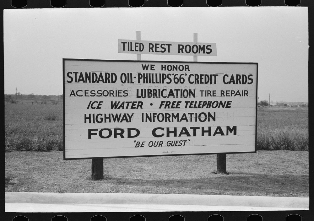 Sign showing various services rendered by service station, Waco, Texas by Russell Lee