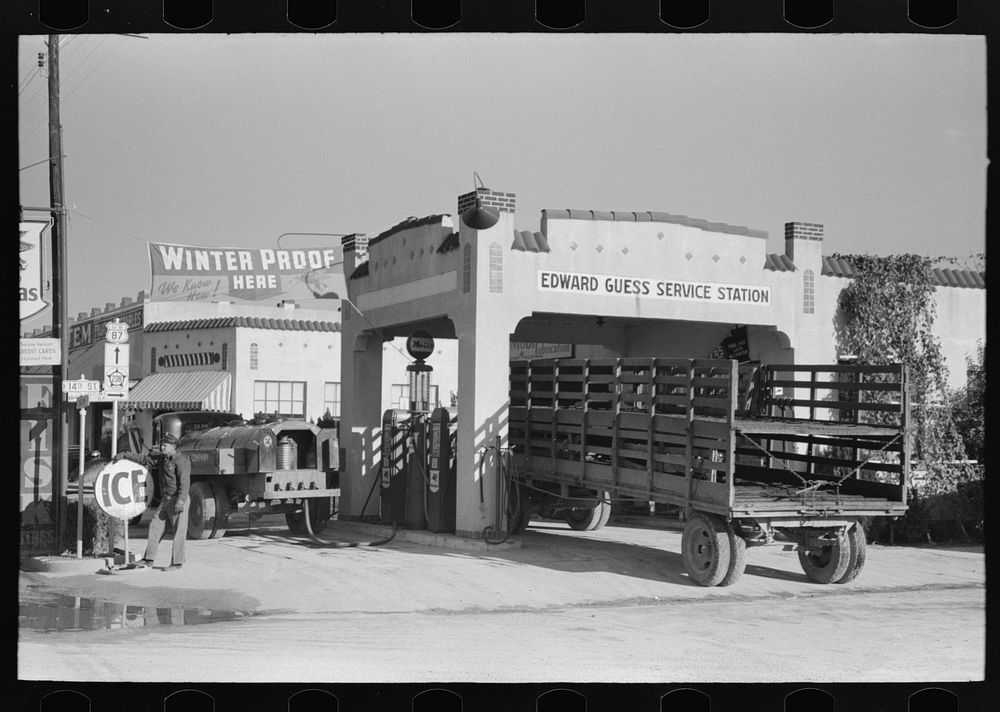 [Untitled photo, possibly related to: Gasoline truck driver getting ready to fill service stations tank with gasoline, San…