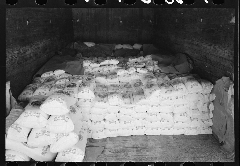 [Untitled photo, possibly related to: Flour in railroad freight car at wholesale grocers, San Angelo, Texas] by Russell Lee