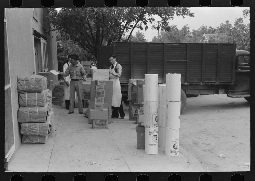 Receiving supplies at retail grocery, San Angelo, Texas by Russell Lee