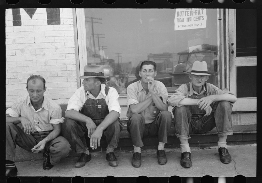 Men sitting along sidewalk in farm marketing section of Muskogee, Oklahoma by Russell Lee