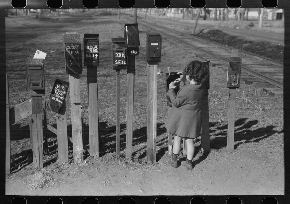 Little girl getting the mail from box, suburb of Oklahoma City, Oklahoma by Russell Lee