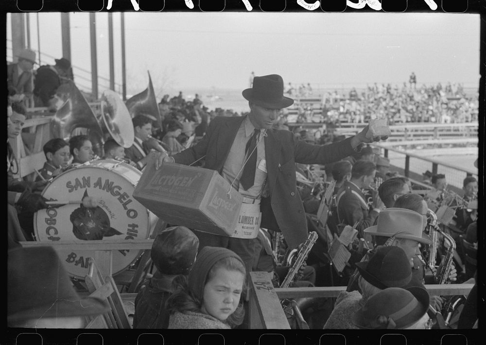 Peanut salesman in the grandstand during the rodeo at the San Angelo Fat Stock Show, San Angelo, Texas by Russell Lee