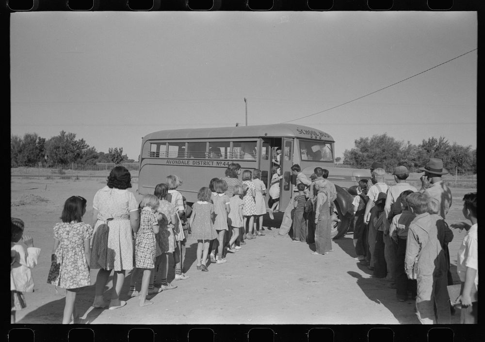 Children of migratory laborers who are living at migratory labor camp at Agua Fria, Arizona, boarding school bus by Russell…