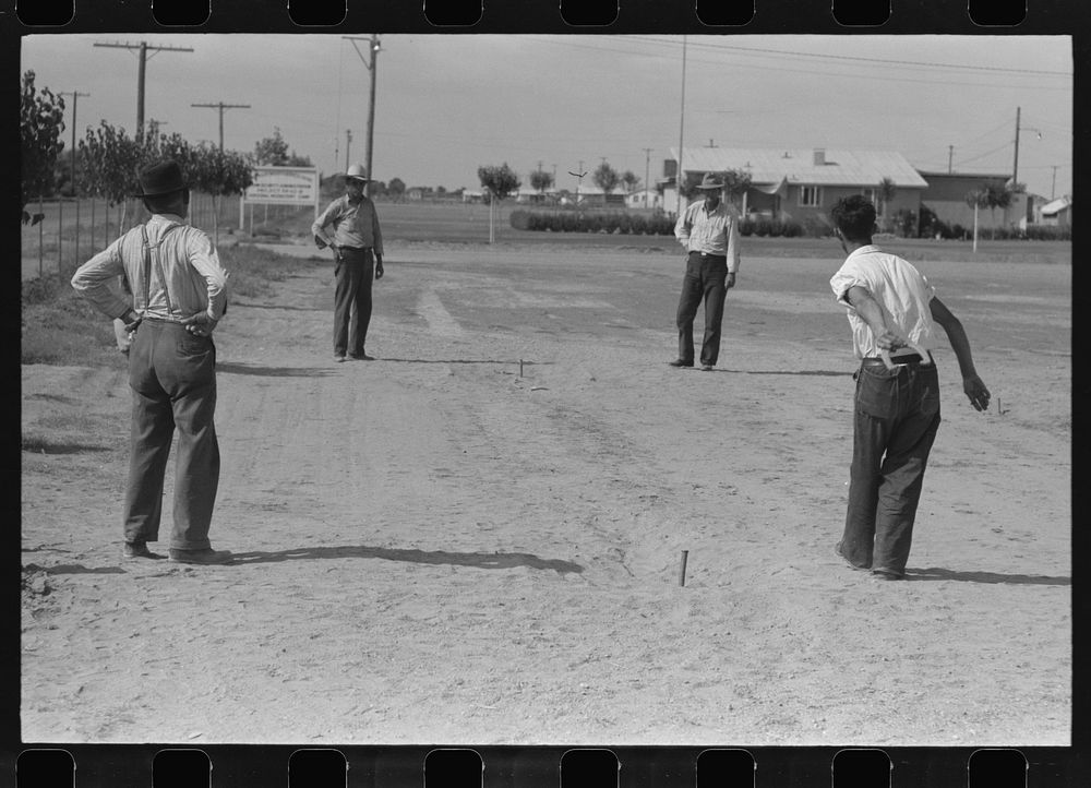 Pitching horseshoes at the Agua Fria Migratory Labor Camp, Arizona by Russell Lee