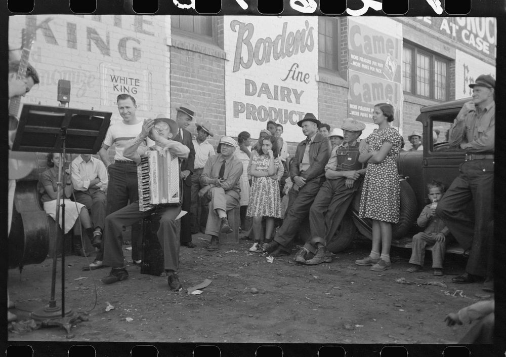 [Untitled photo, possibly related to: Orchestra playing outside a grocery store on Saturday afternoon which is designed to…