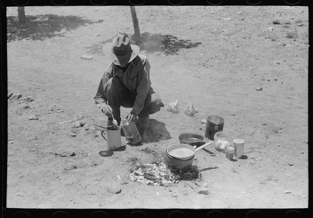 Faro Caudill making coffee for dinner the day he moved his dugout. Pie Town, New Mexico by Russell Lee