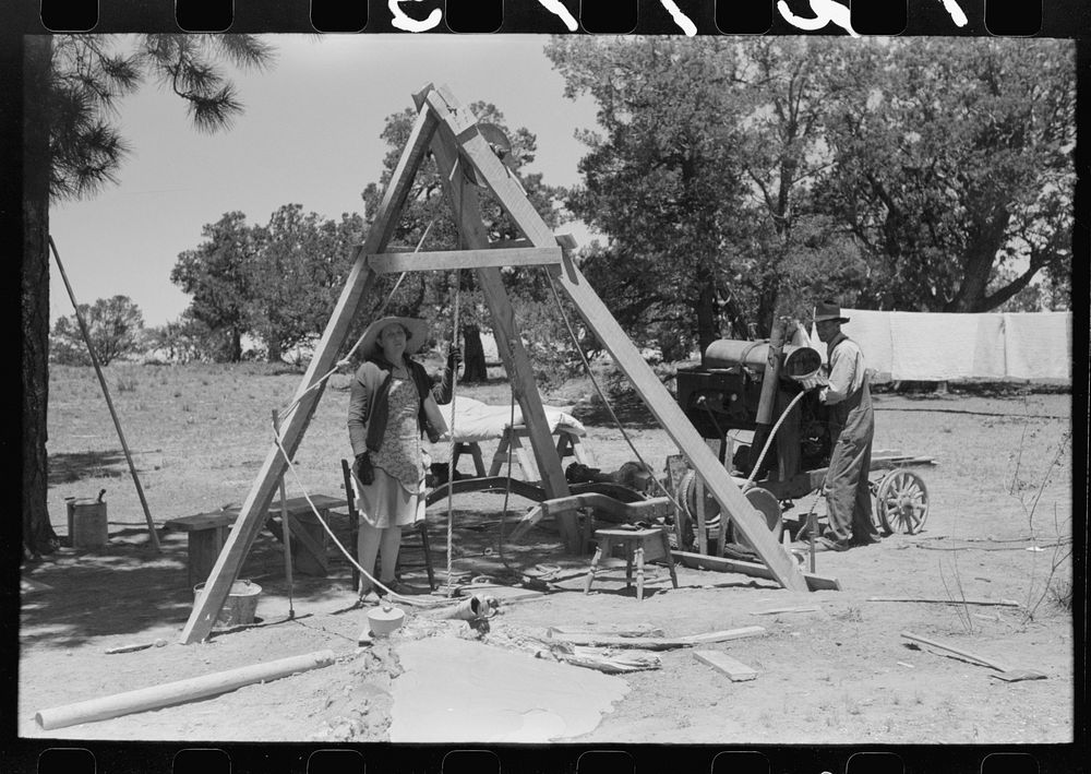 [Untitled photo, possibly related to: Woman guiding the drilling tool for water well drilling. Pie Town, New Mexico] by…