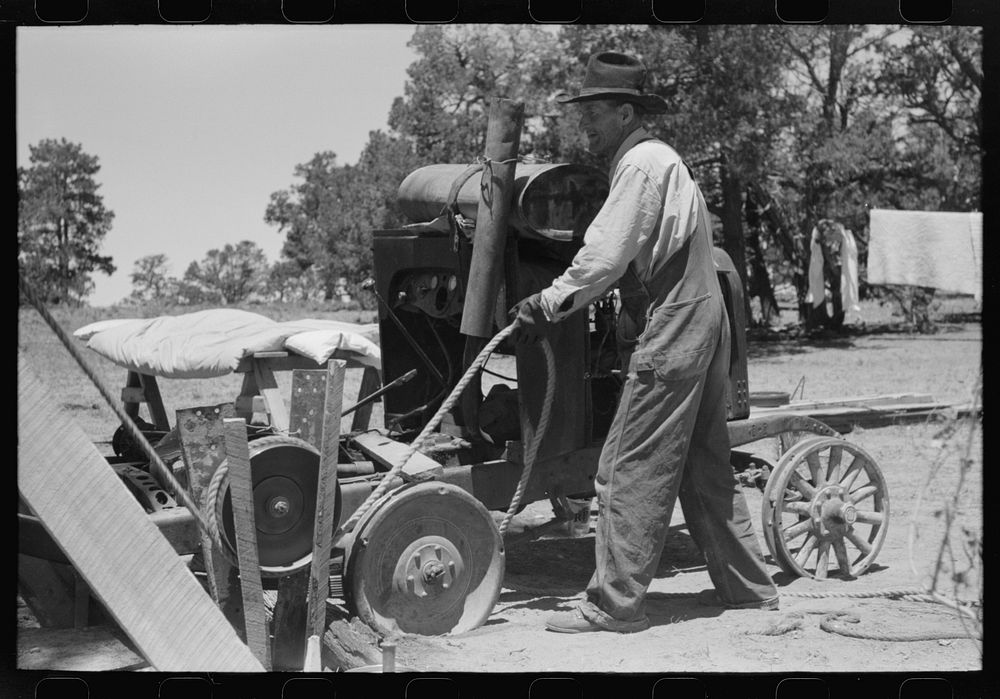 [Untitled photo, possibly related to: Farmer drilling water well. In this picture he is loosening and tightening rope around…