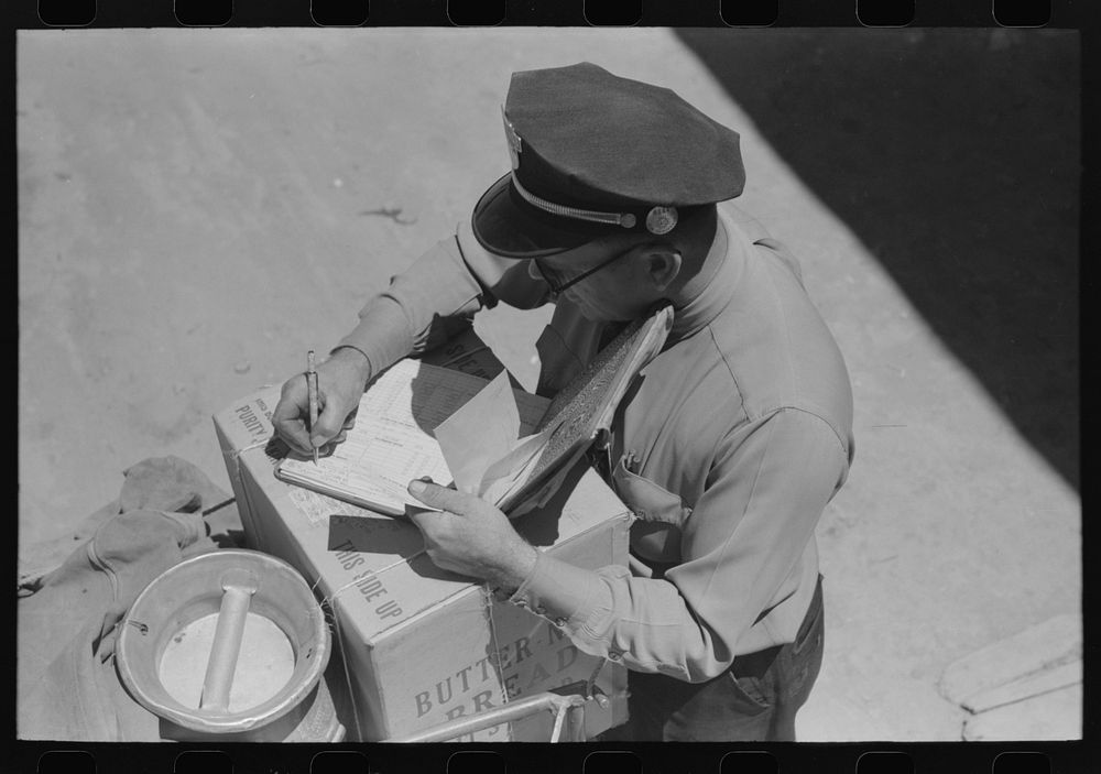 [Untitled photo, possibly related to: Stage driver making out express receipt. Pie Town, New Mexico] by Russell Lee