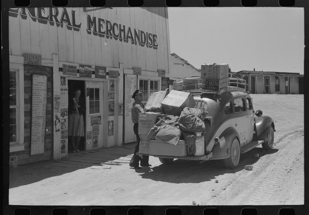 Stage driver unloading packages at general store, Pie Town, New Mexico by Russell Lee