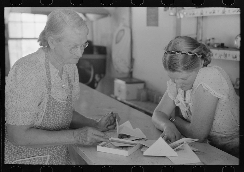 [Untitled photo, possibly related to: Louis Stagg who runs the cafe and her mother looking at greeting cards. Pie Town, New…