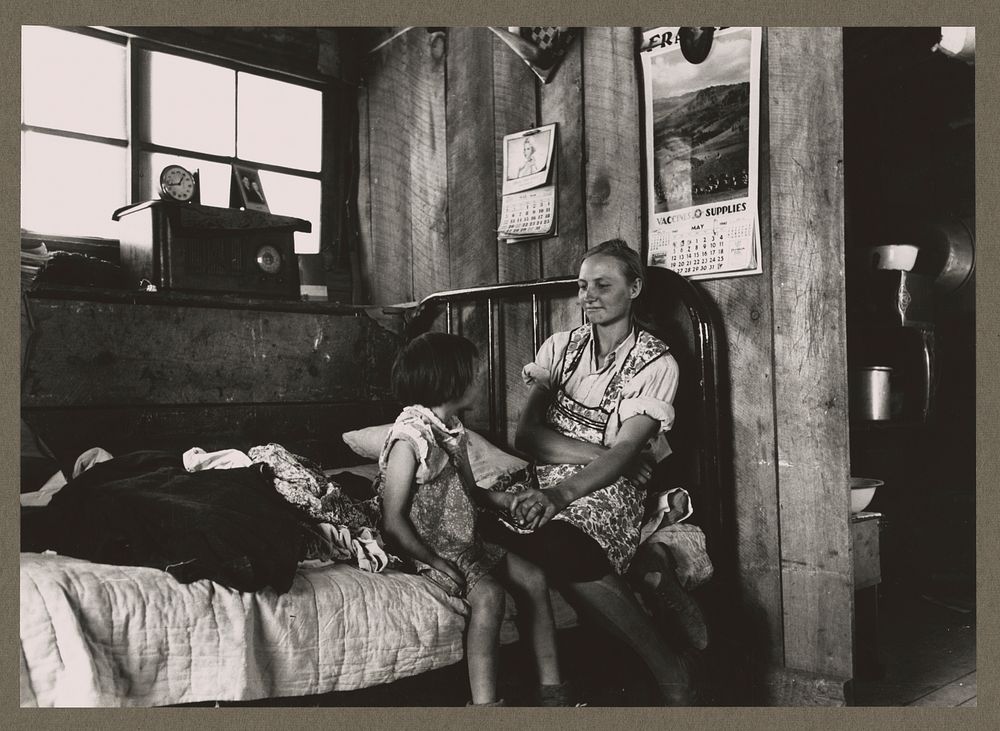 Mrs. Caudill and her daughter in their dugout, Pie Town, New Mexico. The Caudills have one of the few radios in their…