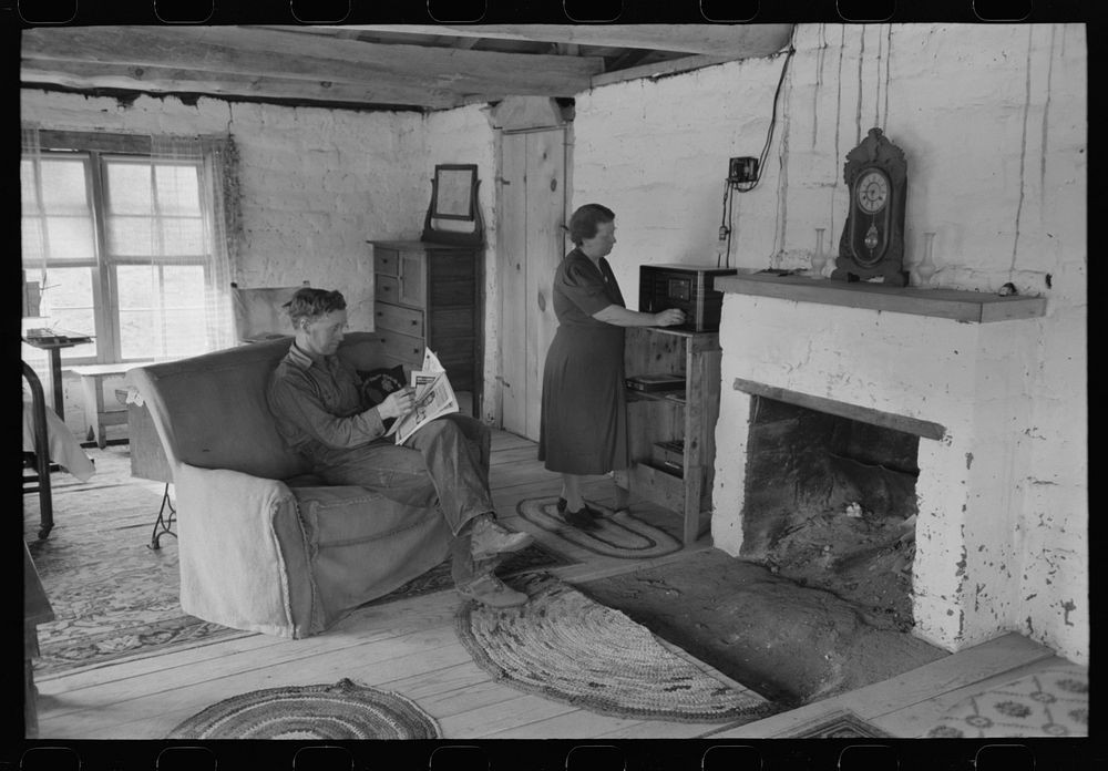 Homesteader and his wife in the living room of their new adobe house. This couple came out seven years ago from Oklahoma and…