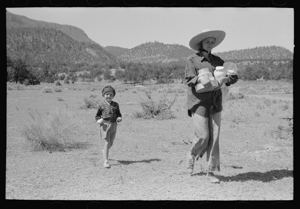Mrs. Caudill and daughter carrying household equipment to new dugout. Pie Town, New Mexico by Russell Lee