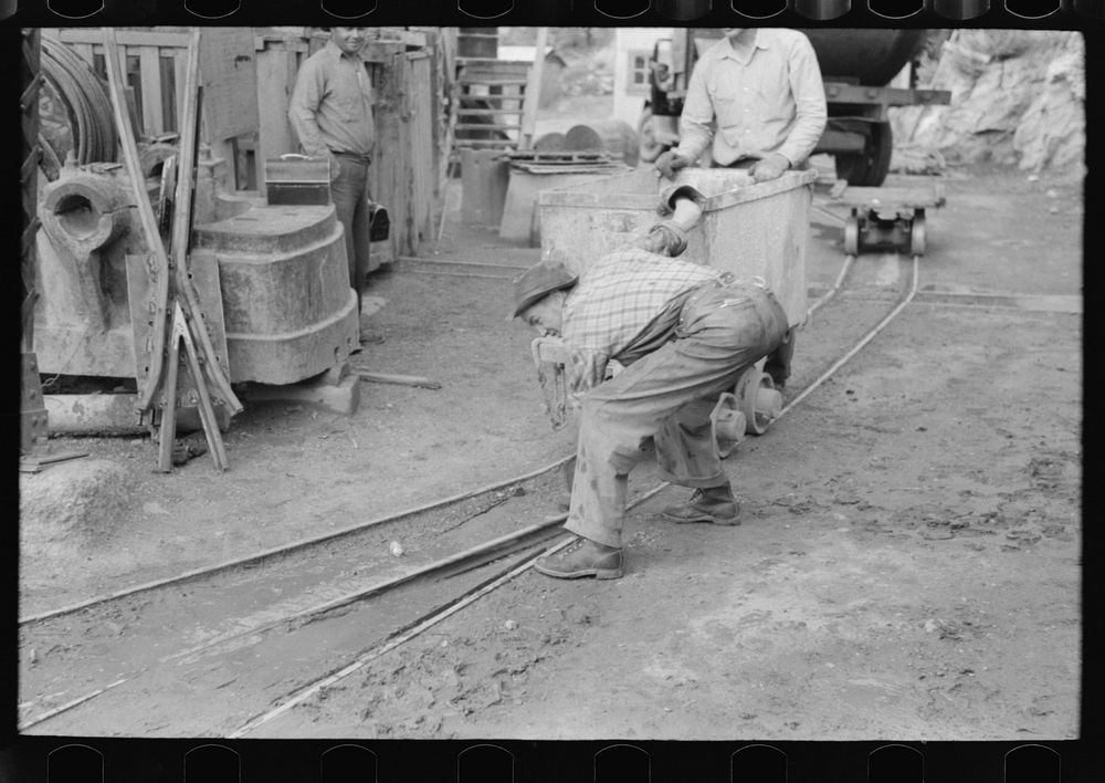 [Untitled photo, possibly related to: Moving ore car on narrow gage railroad track at gold mine, Mogollon, New Mexico] by…