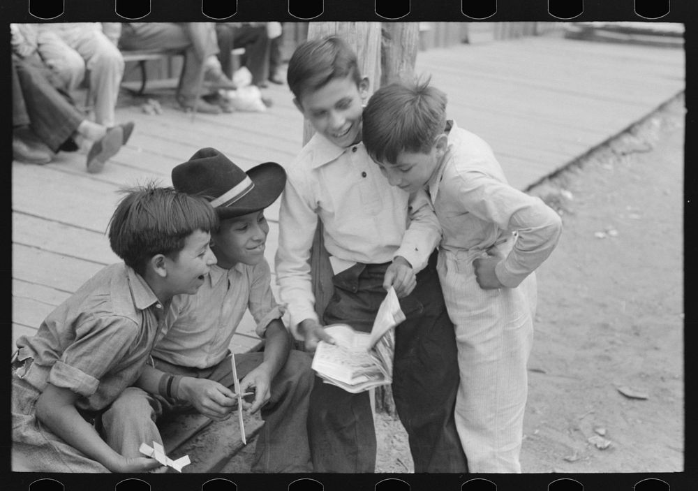 [Untitled photo, possibly related to: Children of gold miners looking at the comics, Mogollon, New Mexico] by Russell Lee