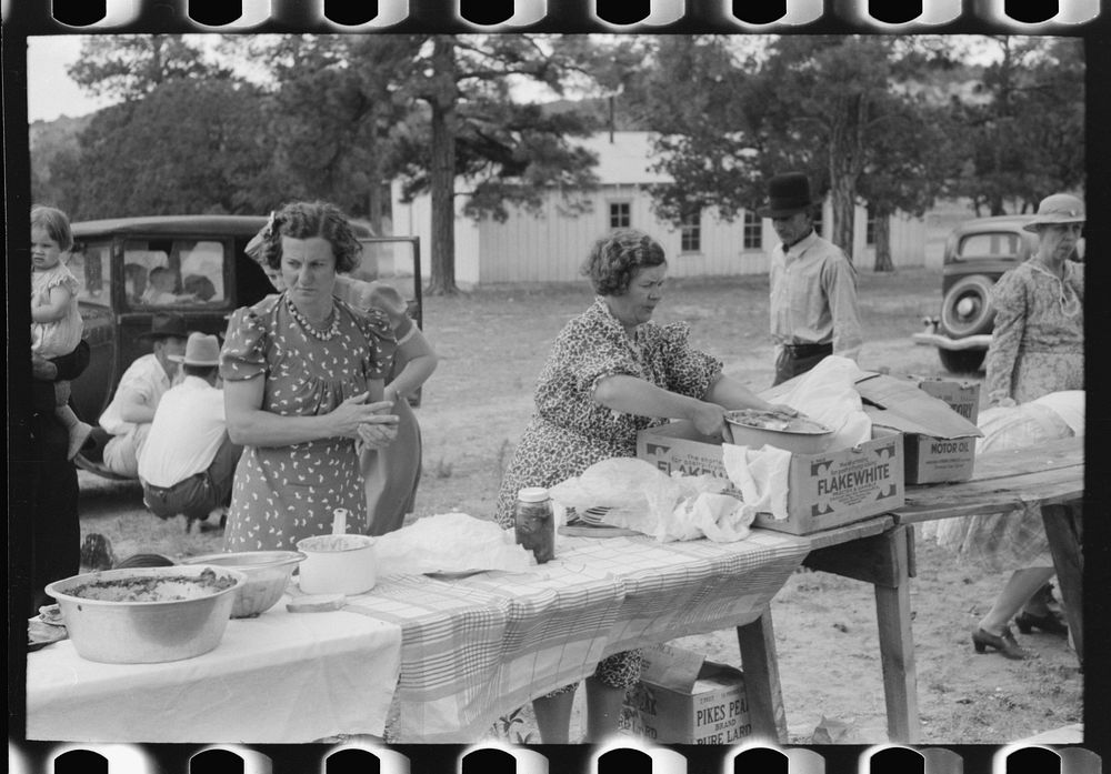 Taking out food for dinner at the day community sing, Pie Town, New Mexico by Russell Lee