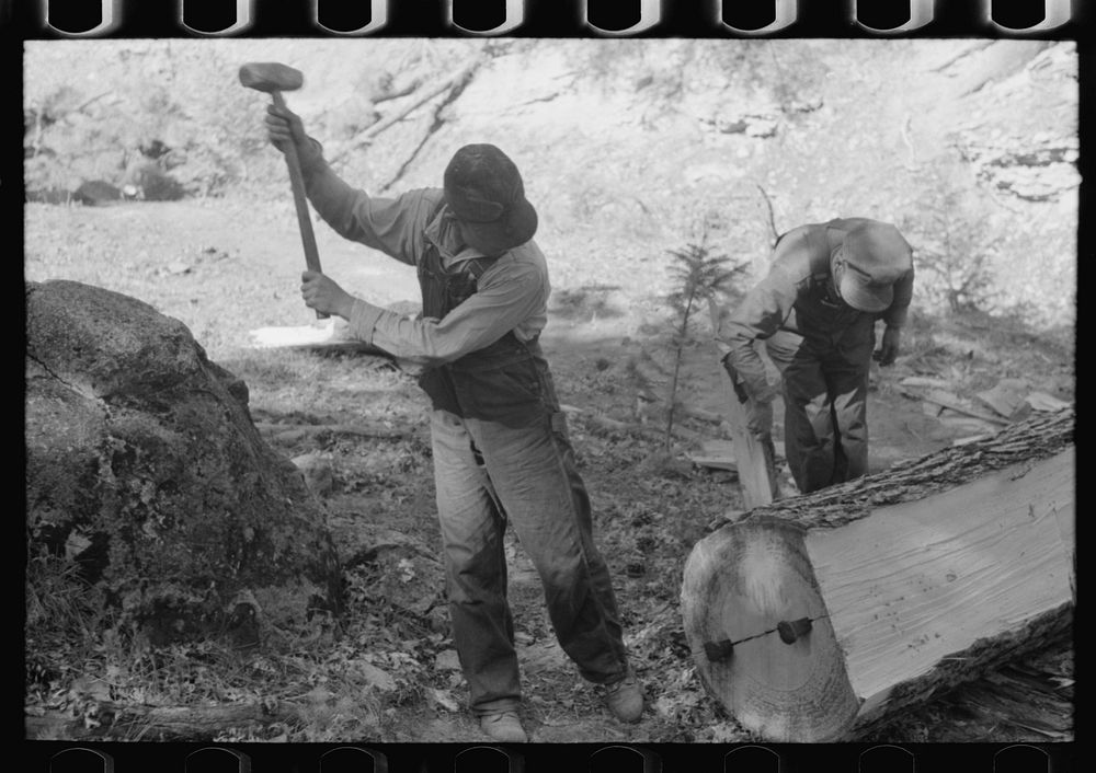 [Untitled photo, possibly related to: Tie workers driving steel wedges into a pine log to split it, Pie Town, New Mexico] by…