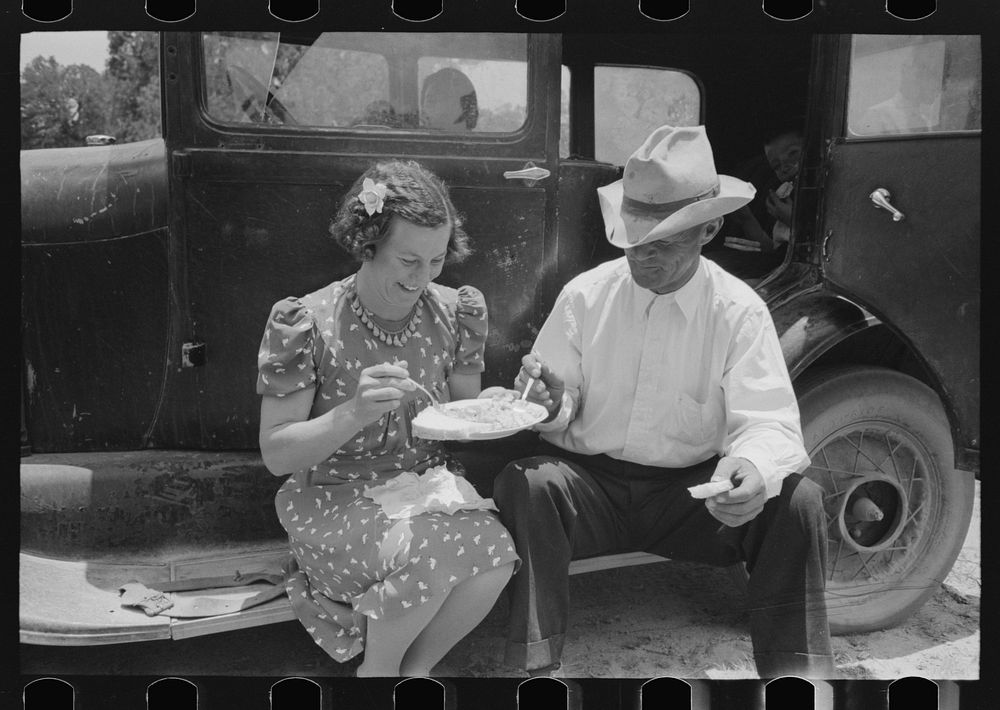 Eating dinner at the all day community sing, Pie Town, New Mexico by Russell Lee