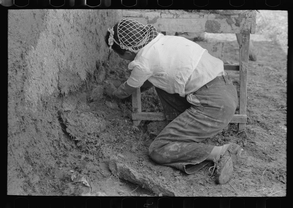 Plastering near the ground is carefully done, all old disintegrating plaster being removed. Chamisal, New Mexico by Russell…