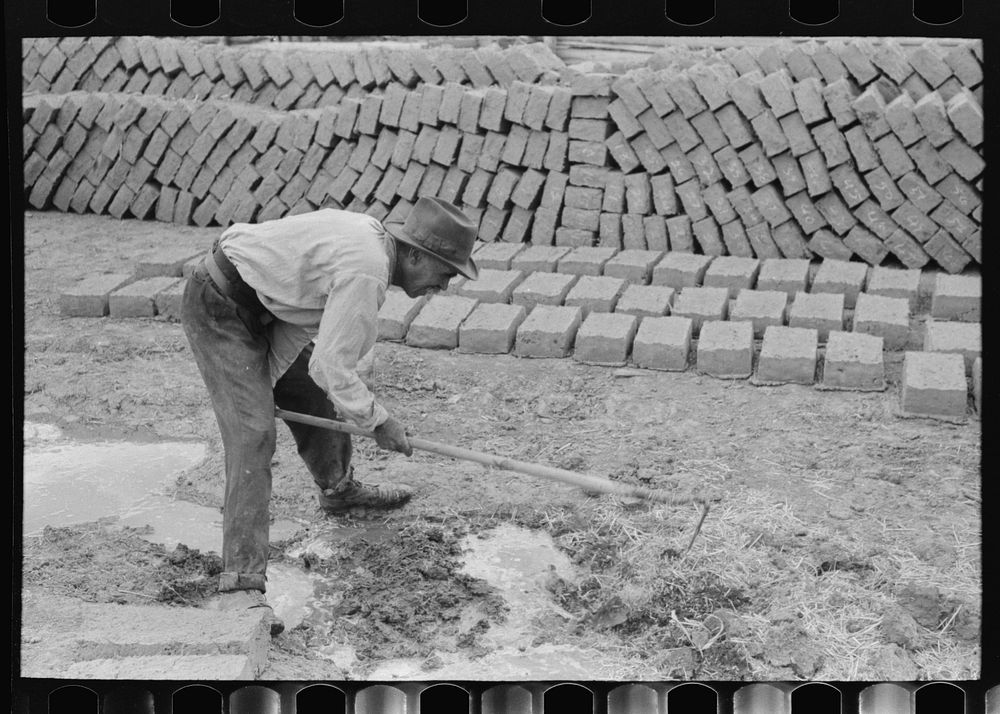 [Untitled photo, possibly related to: Mixing adobe for making bricks, Chamisal, New Mexico] by Russell Lee