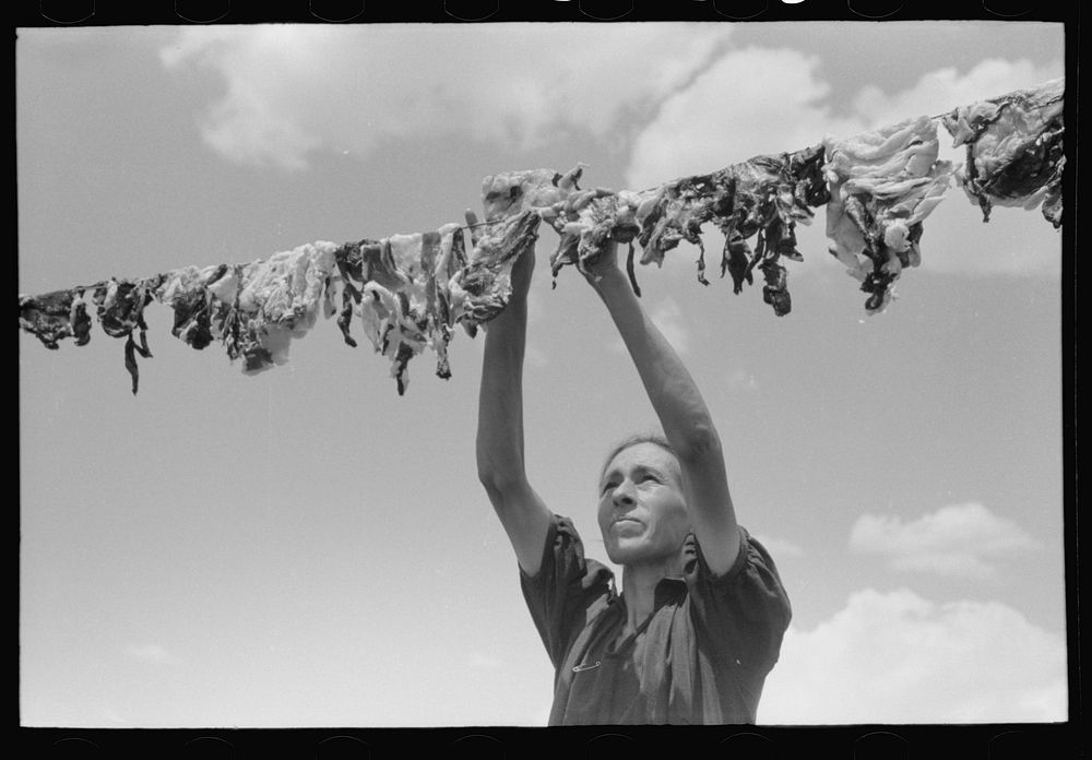 [Untitled photo, possibly related to: Spanish-American woman hanging up meat to dry, Chamisal, New Mexico] by Russell Lee