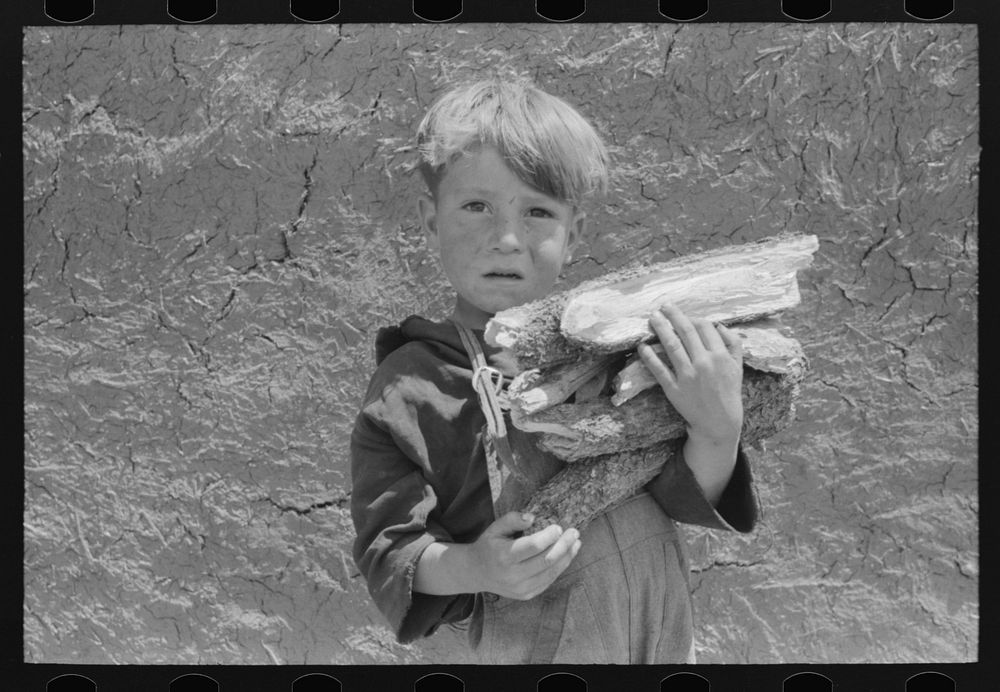 [Untitled photo, possibly related to: Spanish-American boy with an armful of wood. Chamisal, New Mexico] by Russell Lee