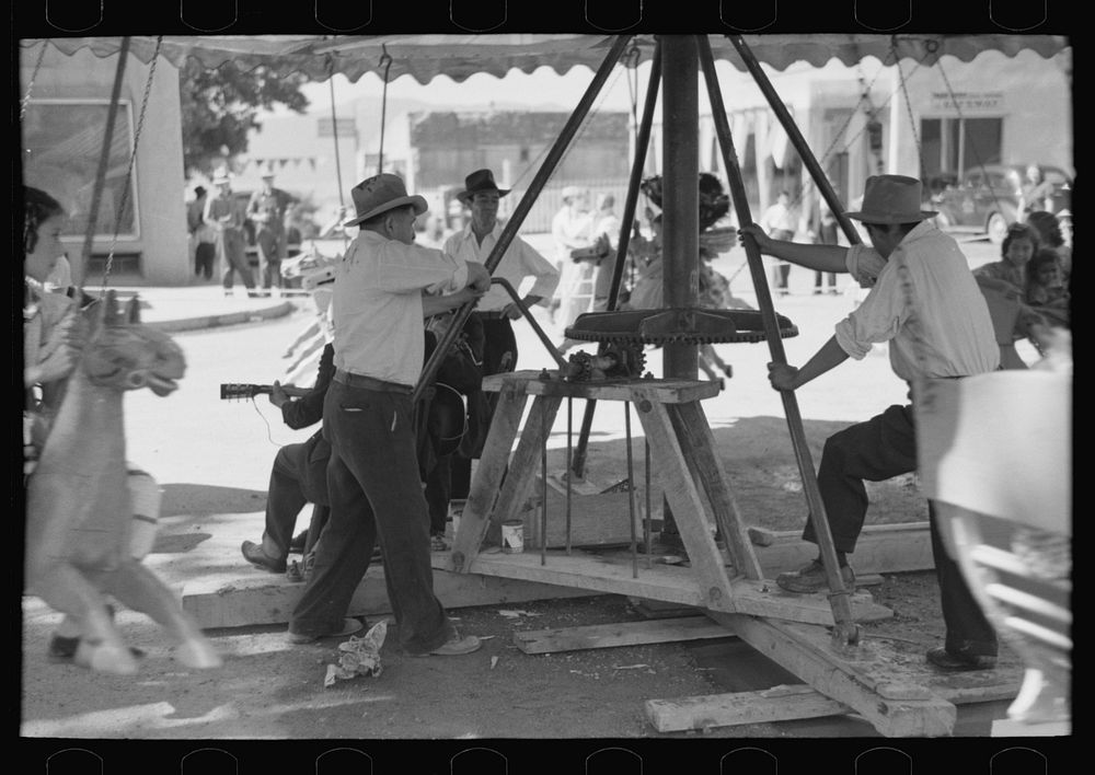 [Untitled photo, possibly related to: Power for the old-fashioned merry-go-round is furnished by two husky Spanish-American…