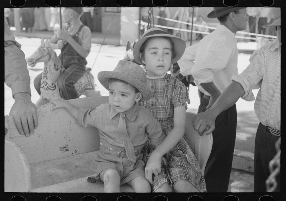 [Untitled photo, possibly related to: Spanish-American children waiting for a ride on the merry-go-round, Fiesta, Taos, New…