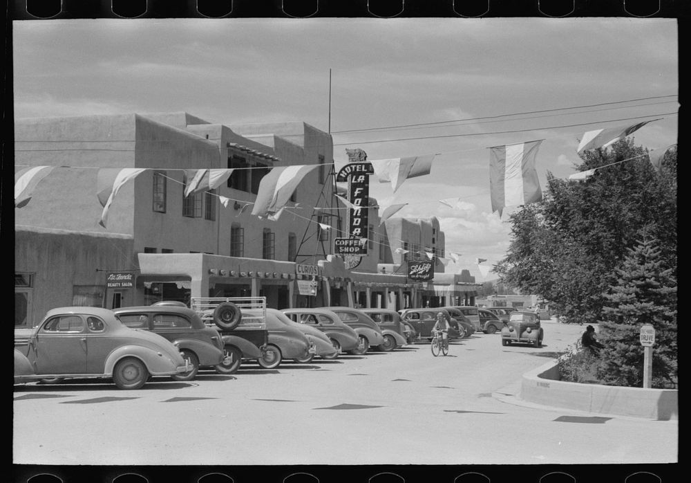 Hotel in the square in fiesta regalia. Taos, New Mexico by Russell Lee