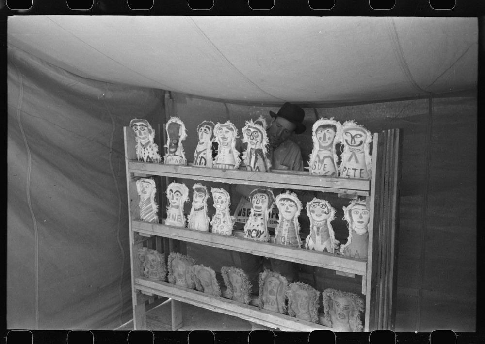 Knocking down dolls at booth at fiesta, Taos, New Mexico by Russell Lee