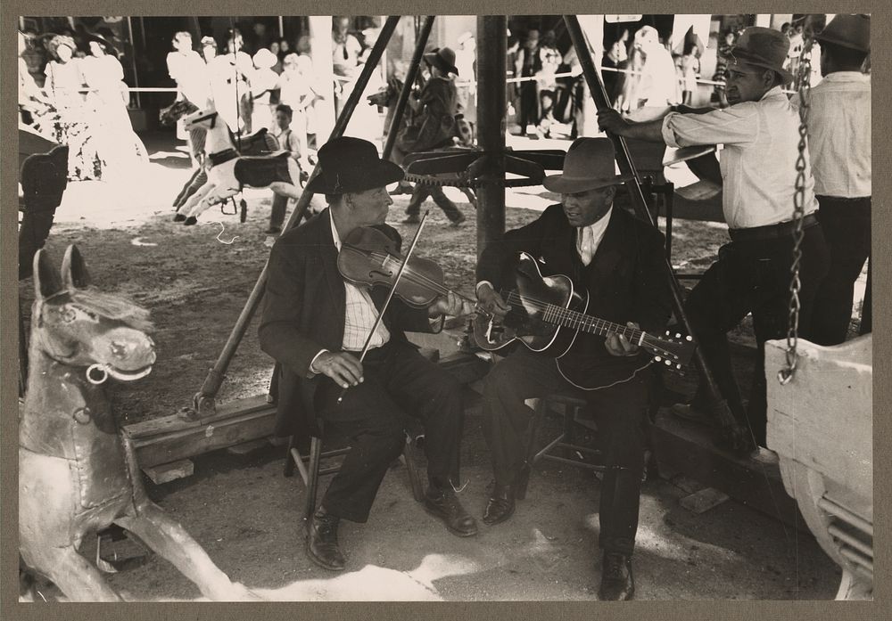 The music for the merry-go-round. Fiesta, Taos, New Mexico by Russell Lee