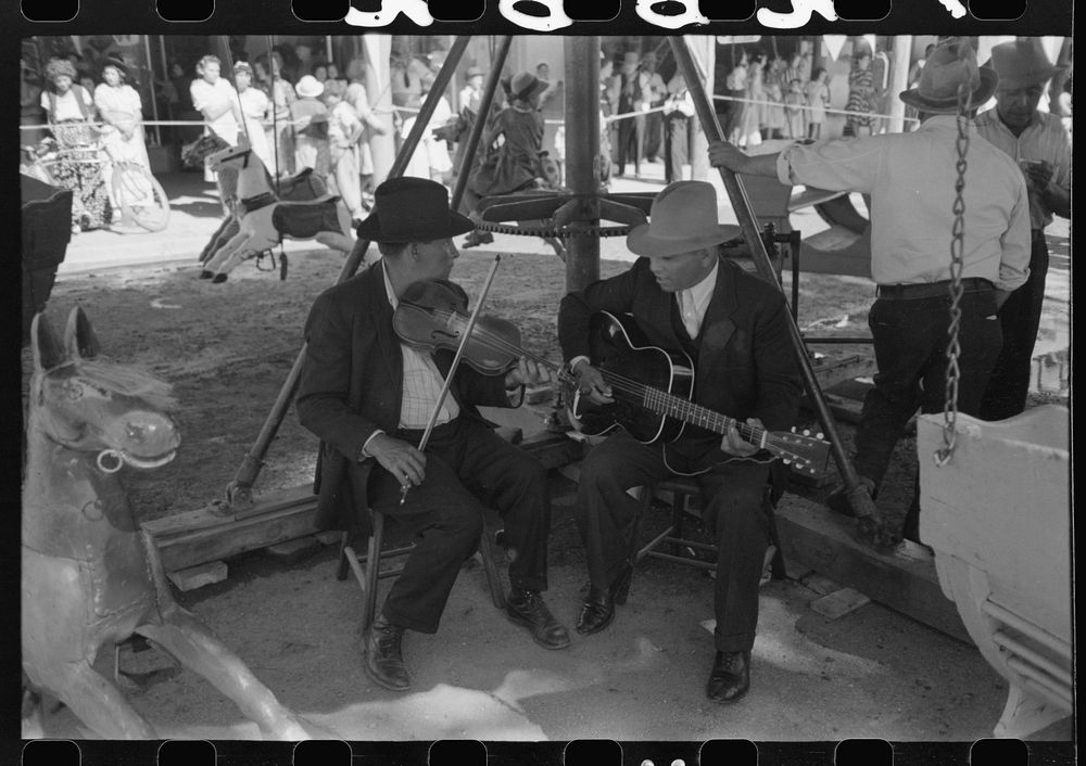 [Untitled photo, possibly related to: The music for the merry-go-round. Fiesta, Taos, New Mexico] by Russell Lee