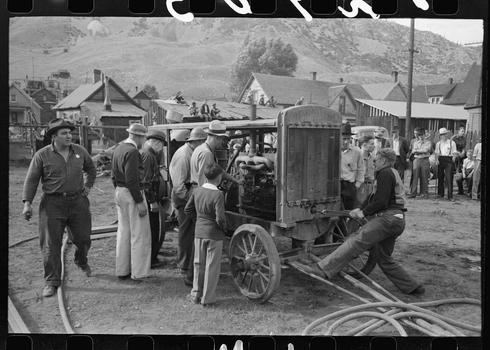 Cranking up motor which will supply power for the miners drilling contest, Labor Day celebration, Silverton, Colorado by…