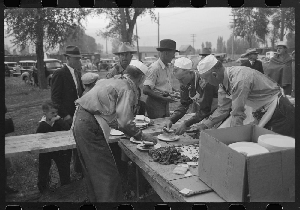 Serving barbecue at the free barbecue on Labor Day at Ridgway, Colorado by Russell Lee