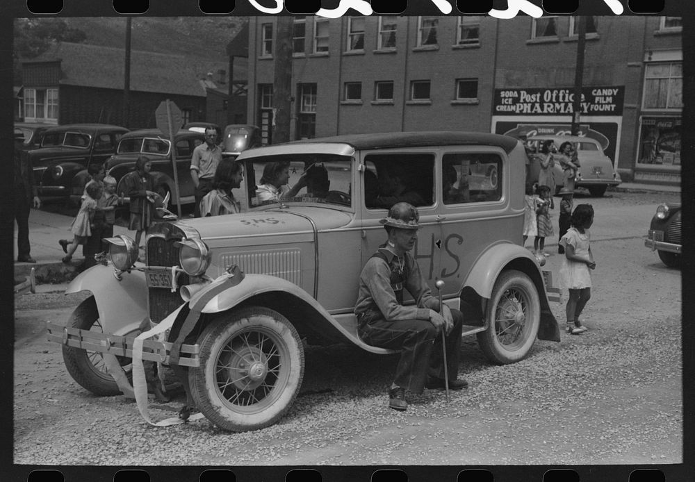 Miners sitting on decorated car during Labor Day celebration, Silverton, Colorado by Russell Lee