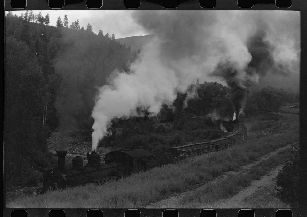[Untitled photo, possibly related to: Train coming up the valley on a narrow gauge track, Ouray County, Colorado. Notice the…