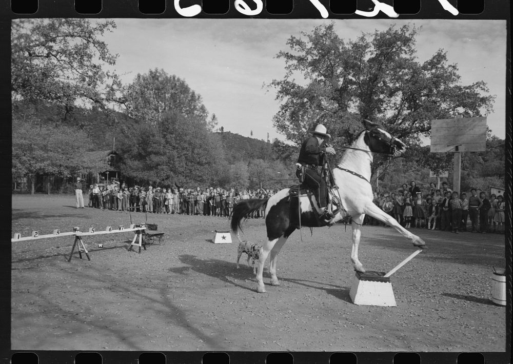 High school horse performs before children of construction workers at Summit City School, Summit City, California by Russell…