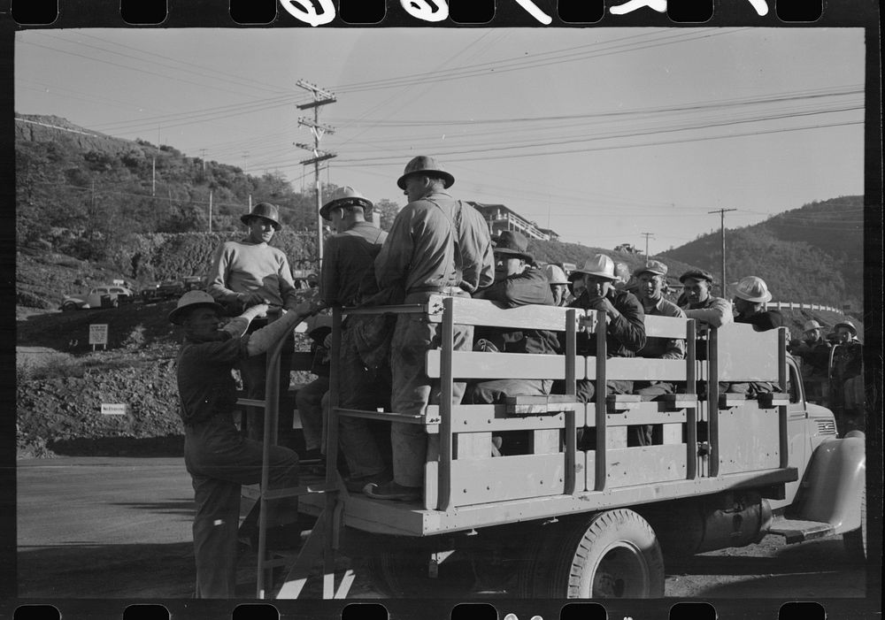 [Untitled photo, possibly related to: Construction workers on truck which will carry them to work on Shasta Dam, Shasta…