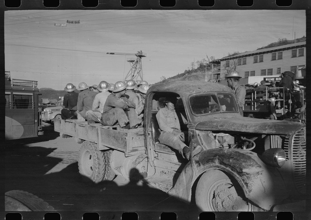 Construction workers on truck which will carry them to work on Shasta Dam, Shasta County, California by Russell Lee