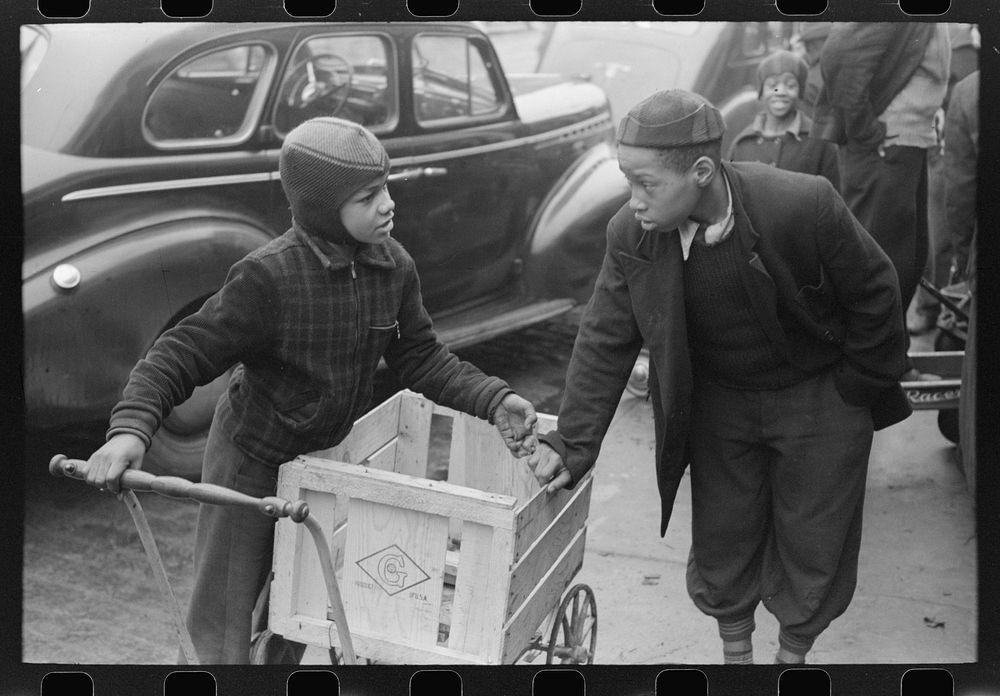 Boys in front of A&P market waiting for jobs to cart home groceries of shoppers, Chicago, Illinois by Russell Lee
