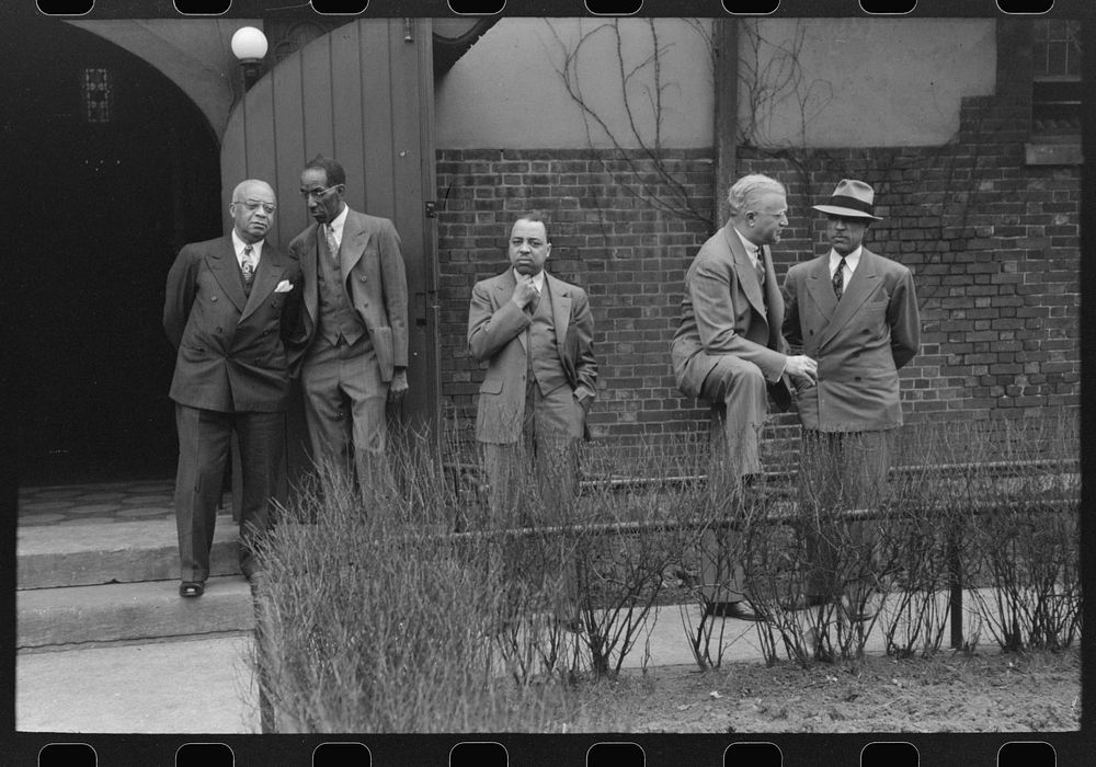 Men outside an Episcopal Church, on Sunday morning, South Side of Chicago, Illinois by Russell Lee