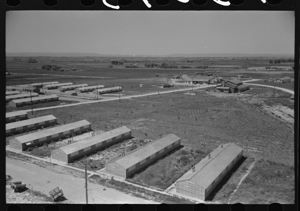 [Untitled photo, possibly related to: Row shelters of farm workers at the FSA (Farm Security Administration) labor camp.…