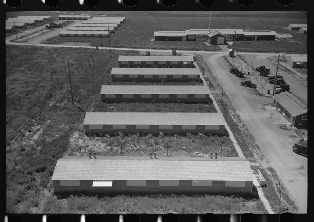 [Untitled photo, possibly related to: Row shelters of farm workers at the FSA (Farm Security Administration) labor camp.…