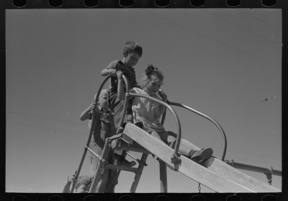 [Untitled photo, possibly related to: Children playing on slide at FSA (Farm Security Administration) labor camp, Caldwell…