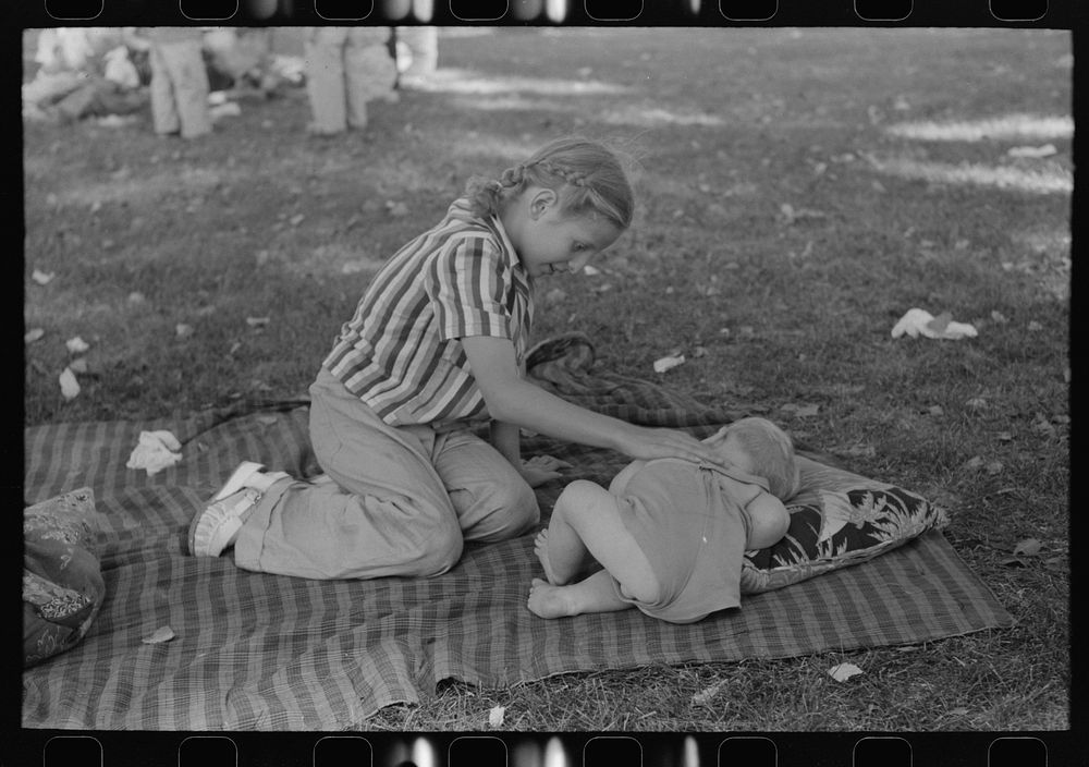 Even at a Fourth of July picnic baby brother must have his nap, Vale, Oregon by Russell Lee