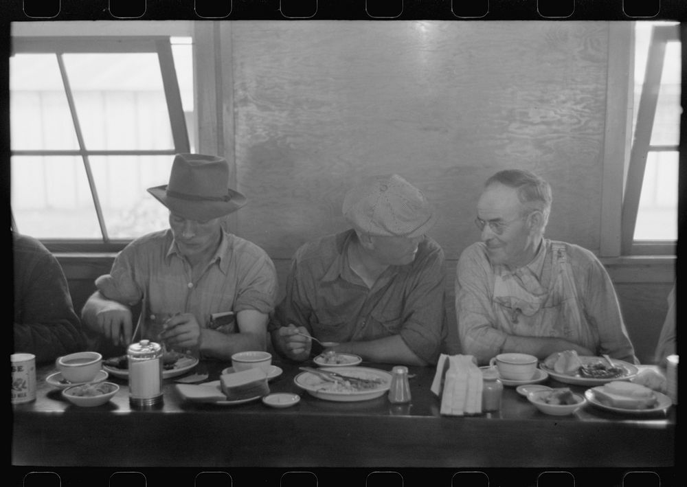 [Untitled photo, possibly related to: Men who work on mechanical hop picking machines have lunch at the company restaurant…